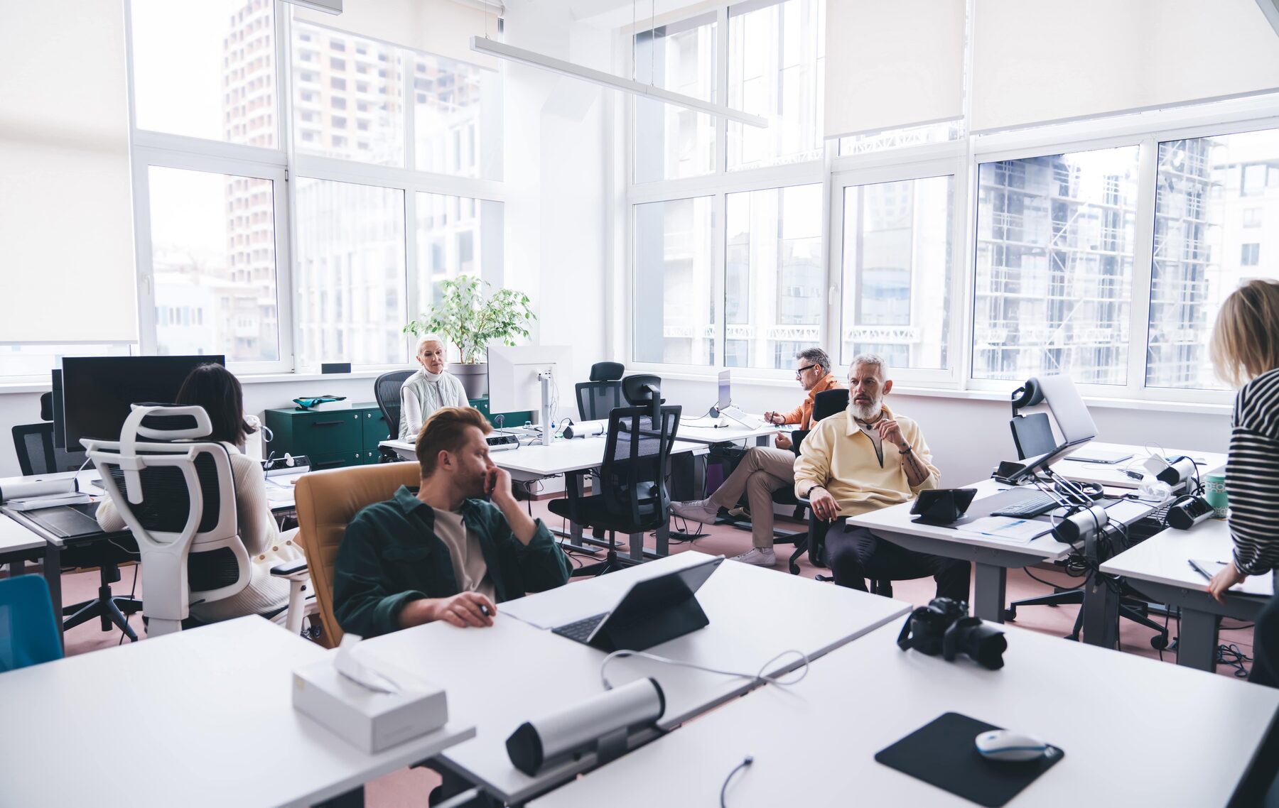 Colleagues collaborating in a calm, modern workplace